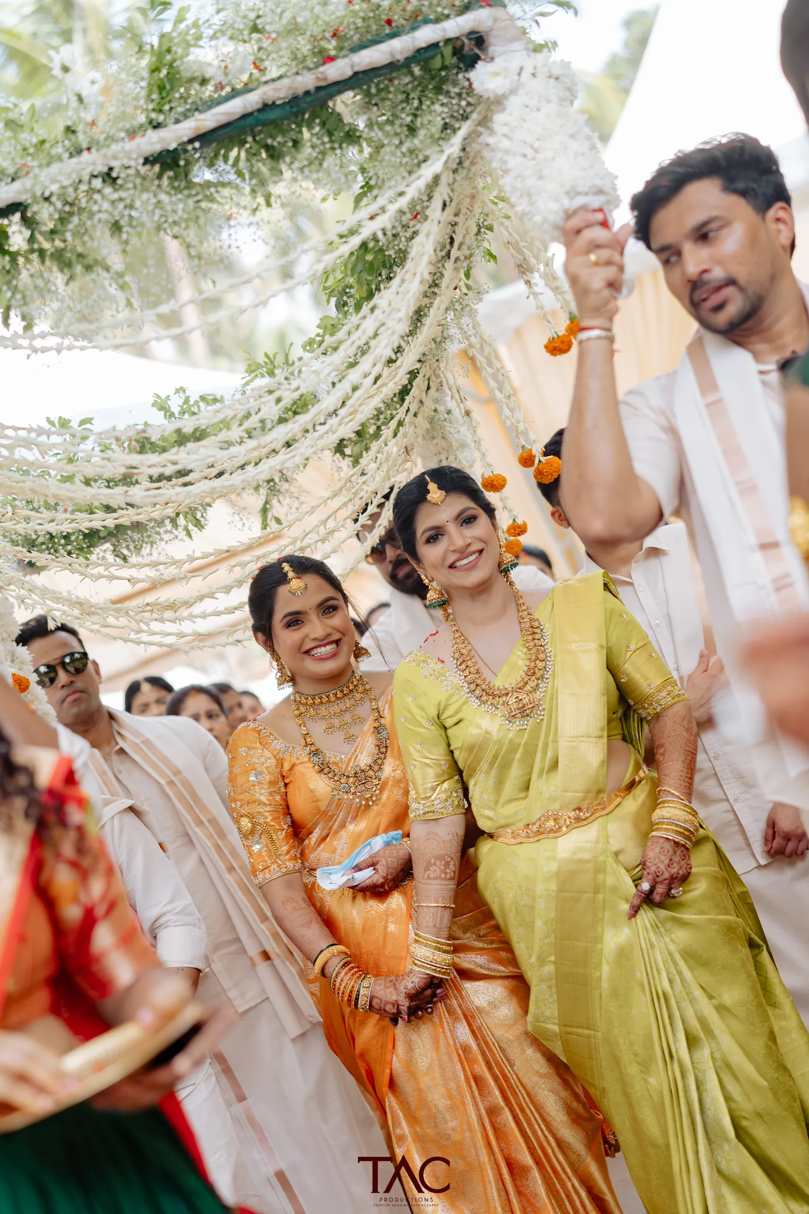 Family candid under the floral canopy, Adyar Gardens Mangalore wedding
